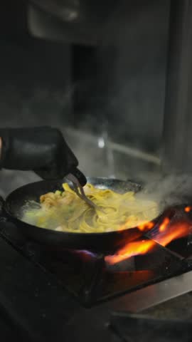 Stirring the pasta on an iron spoon