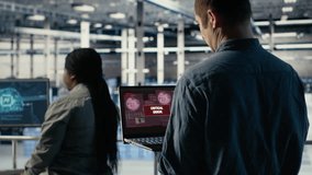 Engineer in server room receives critical error popup on laptop screen, dealing with urgent system issues. Data center worker gets notification about hardware problems affecting performance, camera B - Powered by Shutterstock - Get 15% off with code: PIKWIZARD15