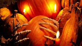 Halloween pumpkins background. Pumpkin in skeletal hands by candlelight. Pumpkins set, bone hands and red candles in the dark. 4k footage - Powered by Shutterstock - Get 15% off with code: PIKWIZARD15