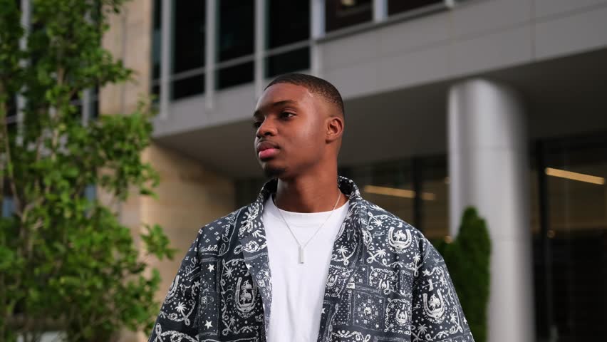 Stylish African American model posing in urban environment showcasing modern fashion trends.