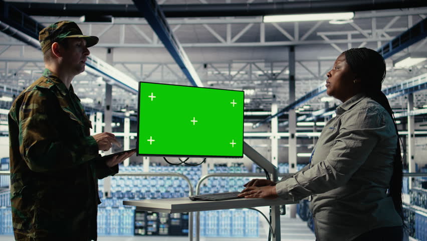 Soldier and female technician use green screen computer to manage server hub systems. African american woman and army commander use mockup workstation in data center, camera A - Powered by Shutterstock - Get 15% off with code: PIKWIZARD15