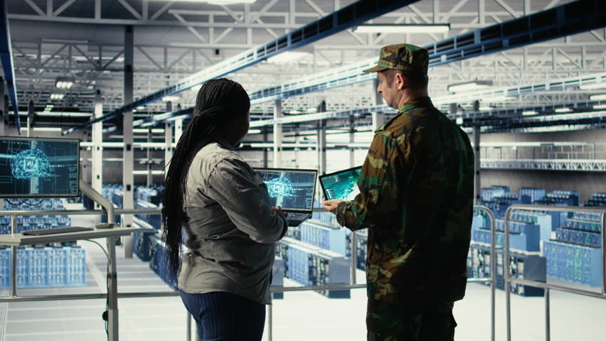 Army commander and software developer in data center integrating AI into radar systems for missile tracking. Soldier and female programmer in server hub analyzing aerial movement on laptop, camera A