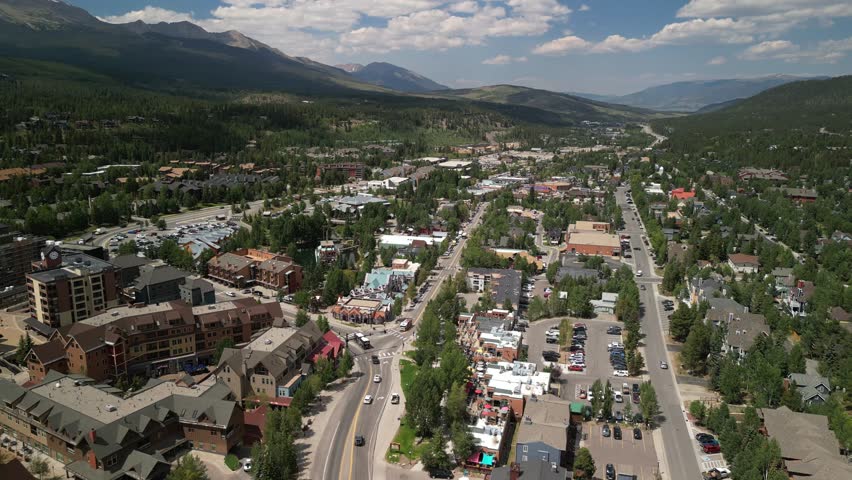 Aerial above hotels and condos in Breckenridge Colorado ski resort on sunny summer day