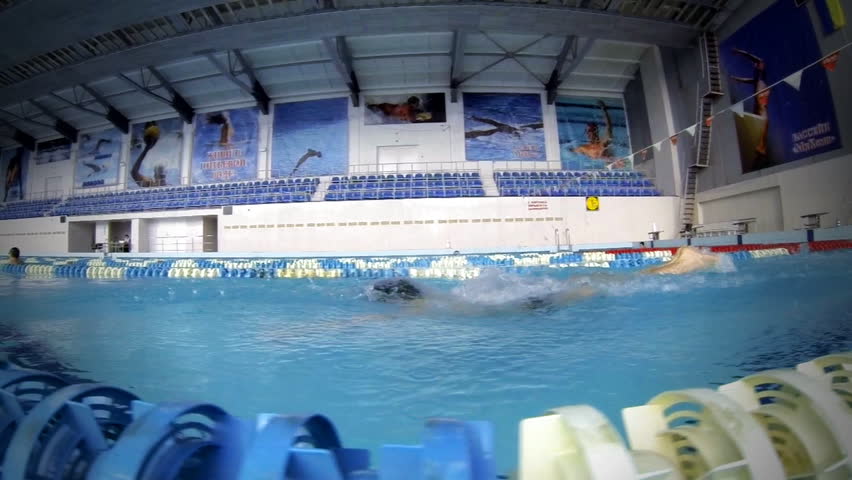 Beautiful slow motion view of athlete swimming butterfly style