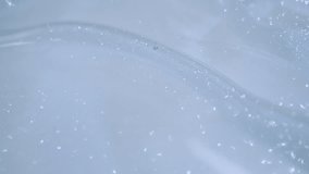 Cosmetic oil or body product with glitter or shimmer. Soft focus. Surface of cosmetic product with air bubbles and shimmer. Blurred background.  - Powered by Shutterstock - Get 15% off with code: PIKWIZARD15