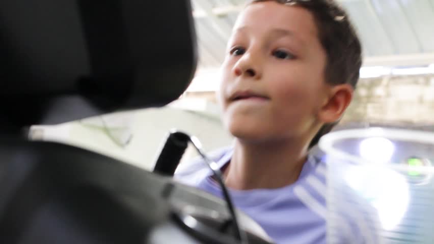A Latin boy performing a strength test with a metal barbell inside a gym in Neiva, Huila, Colombia. A healthy lifestyle and adolescence concept