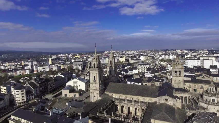 Aerial drone takeoff revealing Lugo Cathedral and the city skyline in the background, Galicia, Spain. UNESCO World Heritage Site.