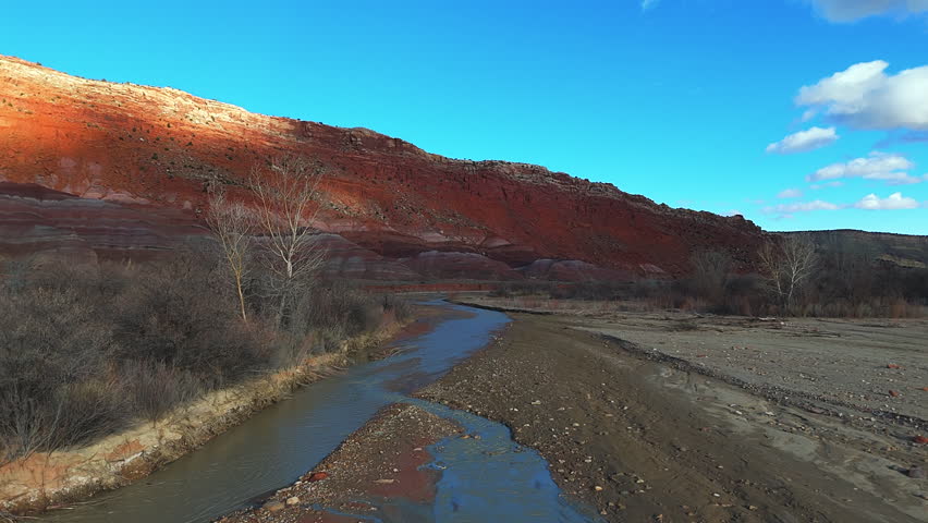 River Flowing By The Canyons Of Grand Staircase-Escalante National Monument In Southern Utah, USA. - aerial shot