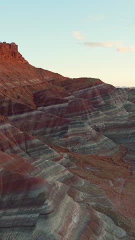 Colored Desert Hills Against Sunset Sky In Rugged Arid Landscape Of Grand Staircase–Escalante National Monument, Utah, USA. vertical drone shot