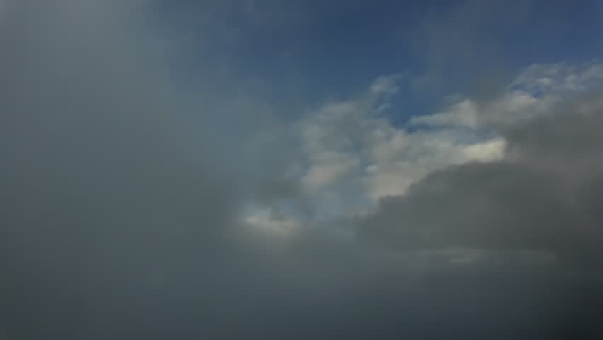 A Pilot’s view taken from a jet ccokpit while flying during climb through layers of ethereal clouds at dawn at supersonic speed.