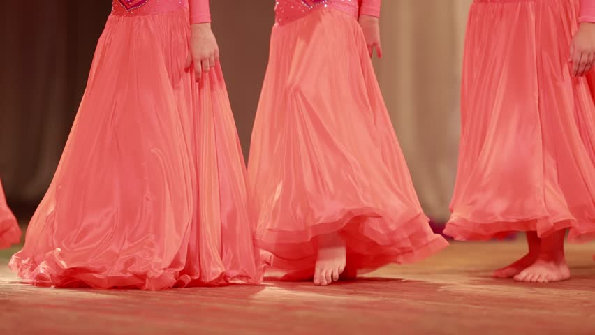 Young woman belly dancer in a oriental costume dancing on stage
