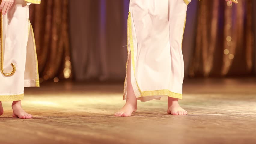 Young woman belly dancer in a oriental costume dancing on stage