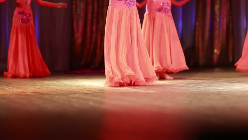 Young woman belly dancer in a oriental costume dancing on stage