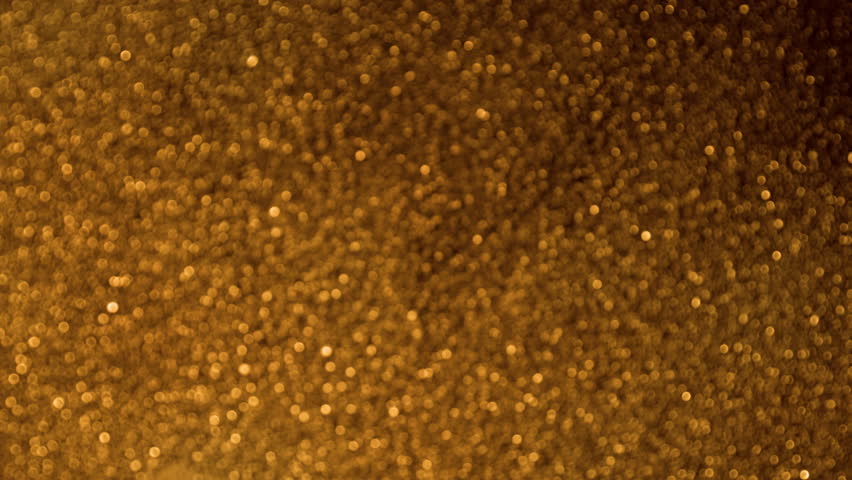 Super Slow Motion Shot of Glittering Golden Background at 1000fps.