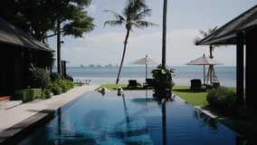 Luxury tropical vacation scene with couple relaxing in infinity pool facing ocean view, palm trees, and blue sky, perfect for travel, honeymoon, and resort lifestyle imagery. - Powered by Shutterstock - Get 15% off with code: PIKWIZARD15