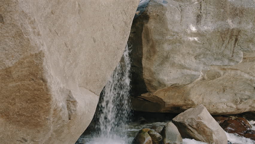 Narrow Waterfall Falling Between Granite Rocks