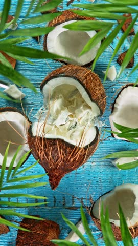 Super Slow Motion Shot of Falling Coconut on Wooden Background, top shot, 1000 fps.