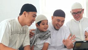 Multi Generation Muslim People Talking On Video Call With Family Members To Forgive Each Other During Eid Celebration - Powered by Shutterstock - Get 15% off with code: PIKWIZARD15
