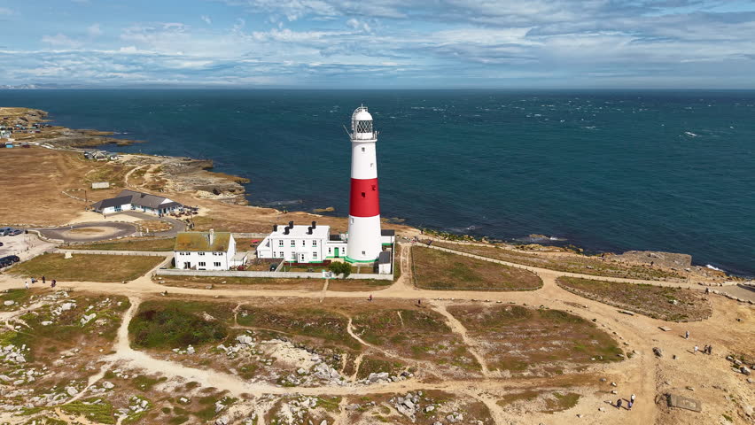 Aerial orbit view of the iconic Portland Bill Lighthouse on the Jurassic Coast, Dorset.
