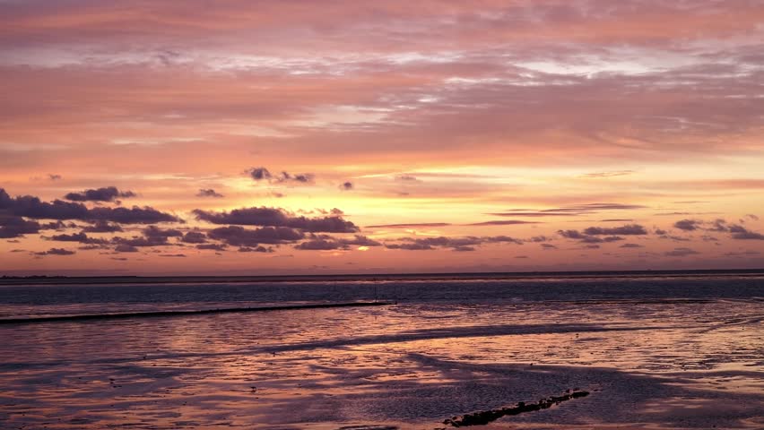 Sunset at Norderhafen (northern harbor) of the Nordstrand peninsula at the Wadden Sea National Park in Schleswig-Holstein, Germany, Europe