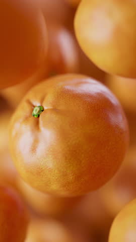 Animation of a group of mandarin. Many tangerines slowly rotate in the background in space. Vertical composition. Defocus. Close-up.
