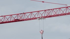 trolley rolls on red tower crane boom at commercial construction site - Powered by Shutterstock - Get 15% off with code: PIKWIZARD15