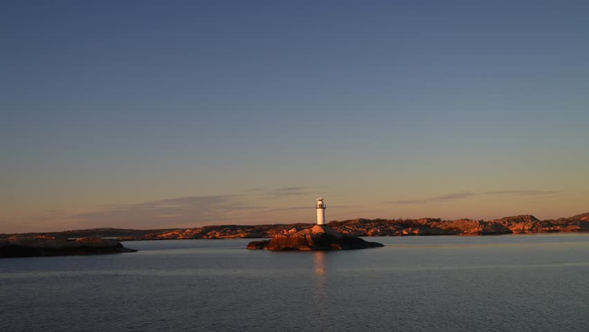 Ferry Boat ride Lighthouse Stromstad Fjord Ursholmen Sweden land of the Svea Sverige calm sea ocean water late arctic afternoon sunset Strömstad Nordkoster enchanting coastal beauty circle motion