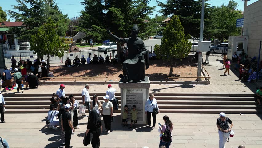 Nevsehir, Turkey - 08 16 2024: Crowd gathering around the Haci Bektas statue before the annual commemoration ceremonies in Hacibektas, Turkey.