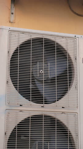 air conditioner on wall of apartment building. ventilation and cooling of home or office during hot weather. installation maintenance of the fan air conditioner. summer heat. High quality video, 4K