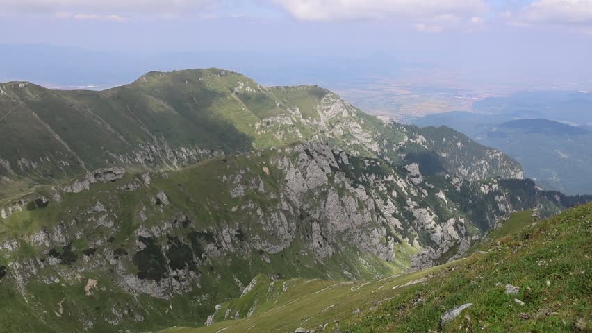 Spectacular aerial view of beautiful high altitude mountains with two impressive deep (500 m deep) and steep valleys in mid summer. The ridges and peaks are also very impressive