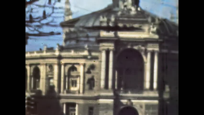 Urban street in historic cultural district. Odessa National Academic Opera Ballet Theater. Elegant architecture. Pedestrian area, heritage, tourism. Vintage film. Old archive. Archival retro 1960s