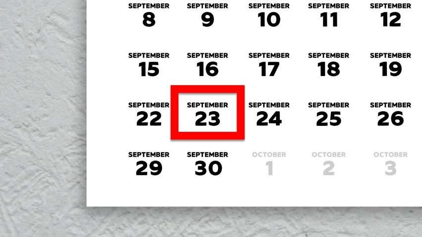 The date September 23rd marked with a red cursor on the wall calendar 2025