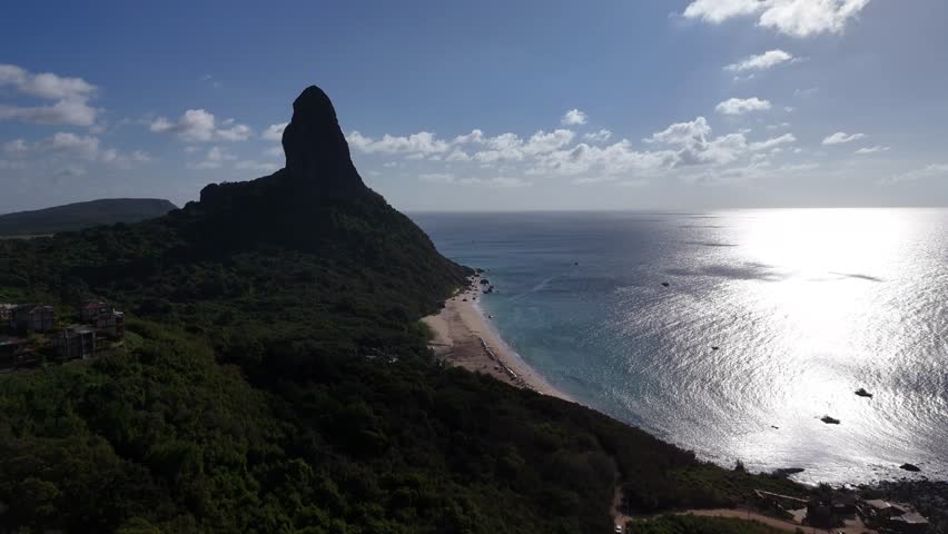 Aerial view of the coastal region of Fernando de Noronha, showcasing its turquoise waters and lush green cliffs. Fernando de Noronha, Brazil
