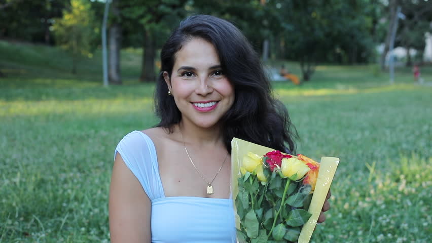 Surprised Hispanic woman getting flowers