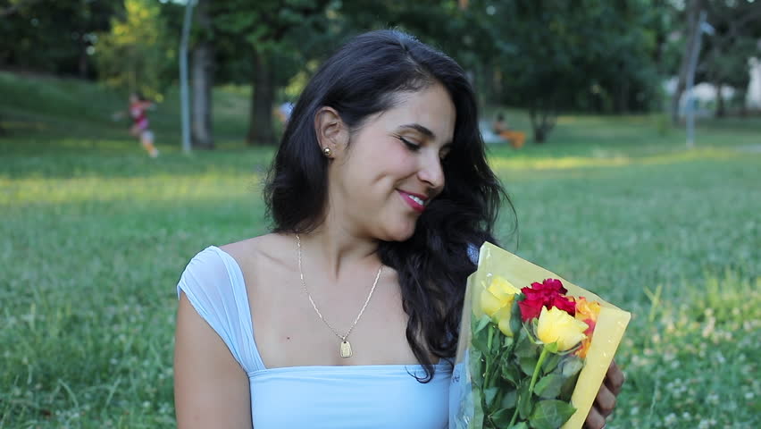 Surprised Hispanic woman getting flowers