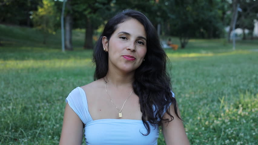 Surprised Hispanic woman getting flowers 
