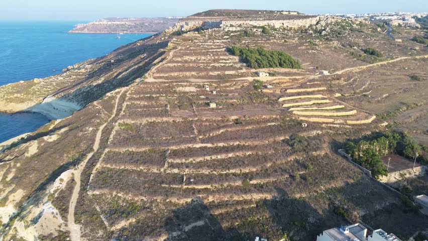 Scenic Aerial View of the Rolling Hills and Mediterranean Sea surrounding Gozo Island, Malta