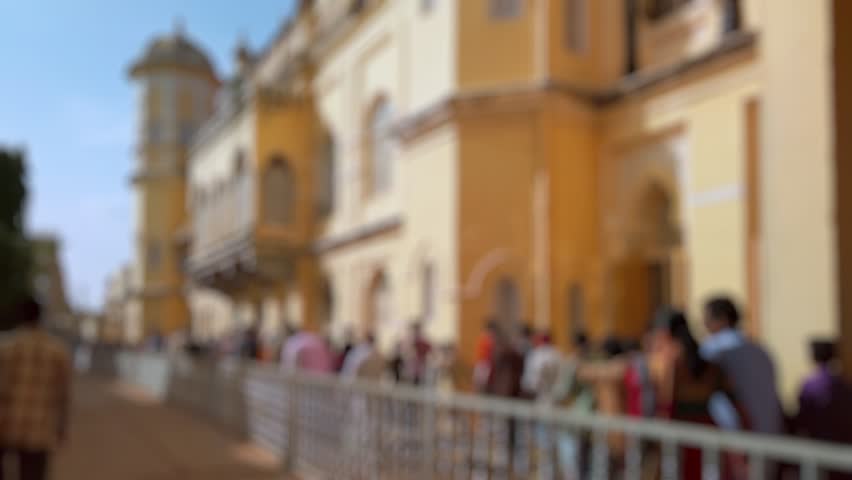 Bokeh view of tourists visit Mysore palace in Mysore, India. Blurred background footage.