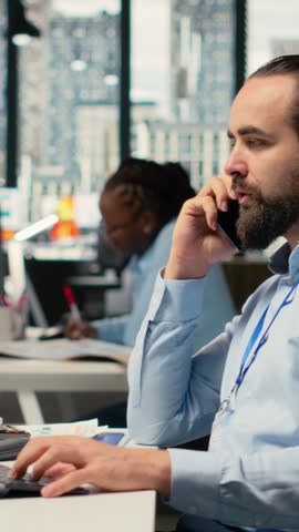Vertical video Investment consultant talking in telephone call with client, reviewing portfolio performance. Trader using smartphone to do phone call with customer, providing financial strategy