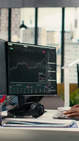 Vertical video Teamworking traders in office work together to resolve security alert after hacker uses exploit to penetrate systems. Team of prop firm colleagues brainstorm how to protect from