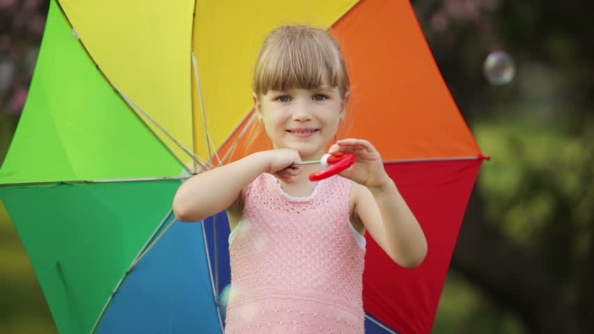 Cute girl with umbrella smiling
