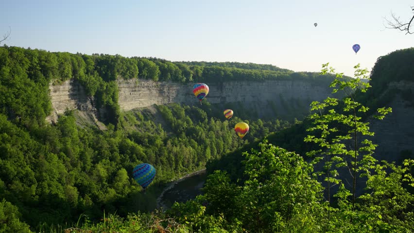 Hot air balloons in Letchworth State Park, New York, going through the canyon.