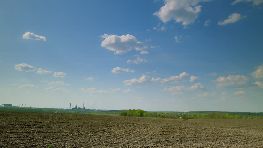 A Beautiful Scenic Landscape Featuring a Cloudy and Expansive Sky Over Vast Agricultural Land