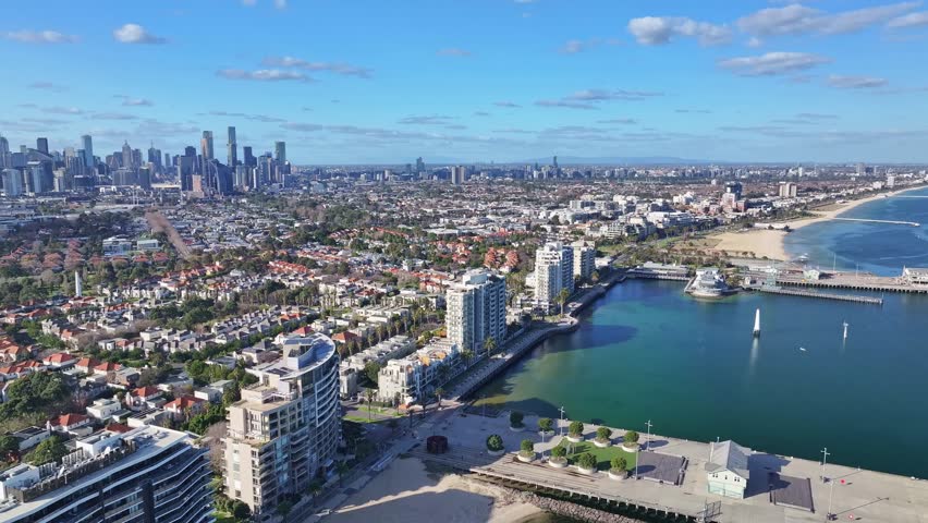 Aerial view of Port Melbourne waterfront promenade and beach with Melbourne city skyline in background