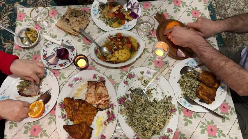 Persian table in New Year night ritual dinner gathering with serving fried fish of Nowruz crispy golden homemade healthy gourmet tasty comfort food seasoning herbs spices fresh sliced traditional Iran