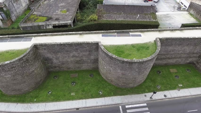 Aerial lateral travelling shot of the exterior towers (cubes) of Lugo’s Roman Wall. UNESCO World Heritage Site, Galicia, Spain.