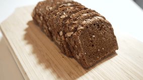 Dark seed bread close-up. Nutty wholegrain bread with pumpkin seeds rotates, showing its dense texture and crispy crust. Perfect for healthy food visuals. - Powered by Shutterstock - Get 15% off with code: PIKWIZARD15