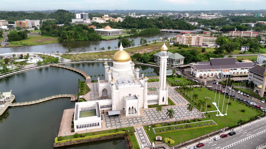 Epic cinematic aerial drone shot of the Omar Ali Saifuddien Mosque in Brunei. Rotating aerial drone shot.