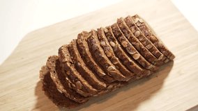 Top view sliced seed bread. Healthy seed bread rotates on a wooden board, showing its thin, even slices and rich texture. Perfect for healthy lifestyle or bakery videos. - Powered by Shutterstock - Get 15% off with code: PIKWIZARD15