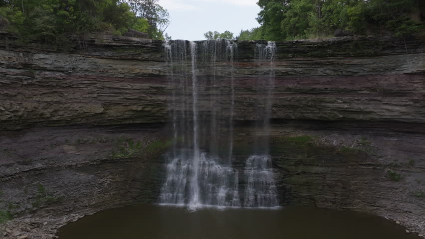 Serene waterfall flows in Balls Falls, Ontario with tranquil atmosphere